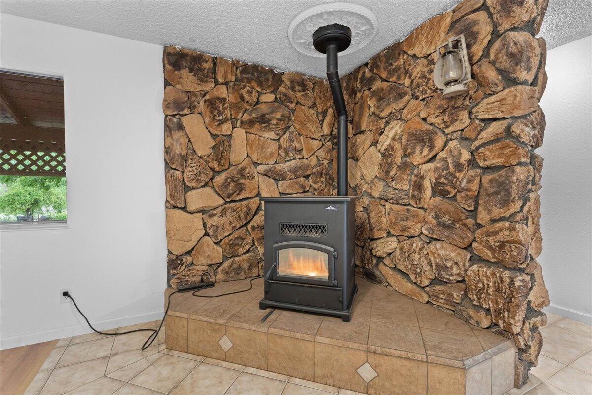 5210 Balls Ferry Road Anderson, CA 96007 - Photo 7 of 68 a living room with a stove and a fireplace