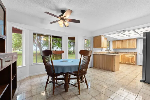 a kitchen with granite countertop cabinets stainless steel appliances a sink and window