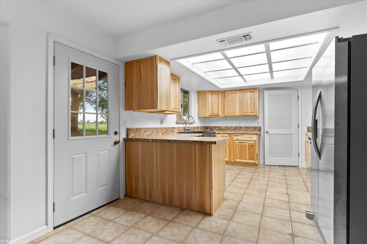 5210 Balls Ferry Road Anderson, CA 96007 - Photo 9 of 68 a kitchen with a refrigerator a sink and cabinets