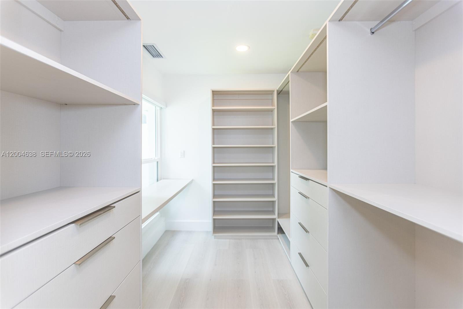 1690 Daytonia Road Miami Beach, FL 33141 - Photo 68 of 88 a view of walk in closet with empty racks