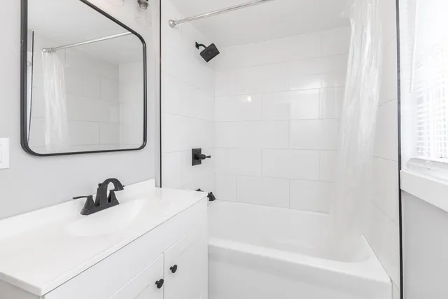 a bathroom with a sink a mirror and a bathtub
