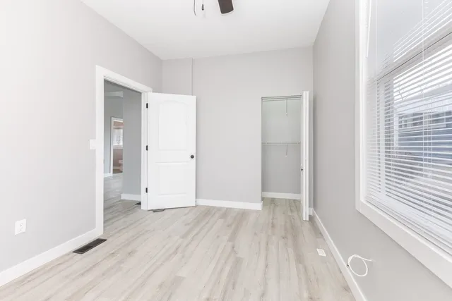 a view of a room with wooden floor and a window