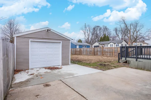 a view of a house with a yard and garage