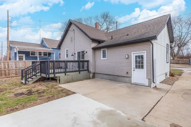a view of a house with wooden fence