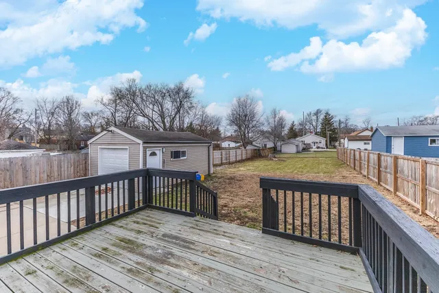 a view of a street with wooden fence