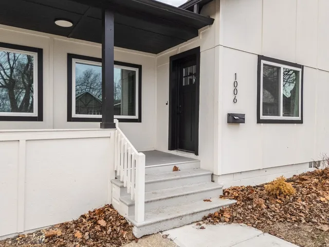 a view of a hallway with wooden floor and a fireplace