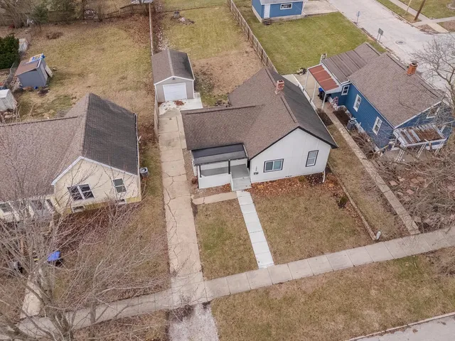 an aerial view of a house with large trees