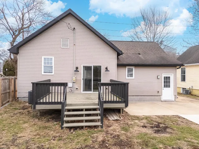 a view of a house with backyard and sitting area