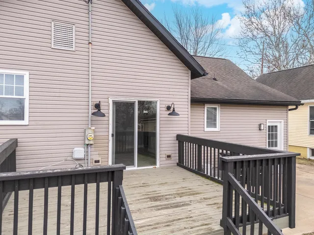 a view of a house with wooden deck