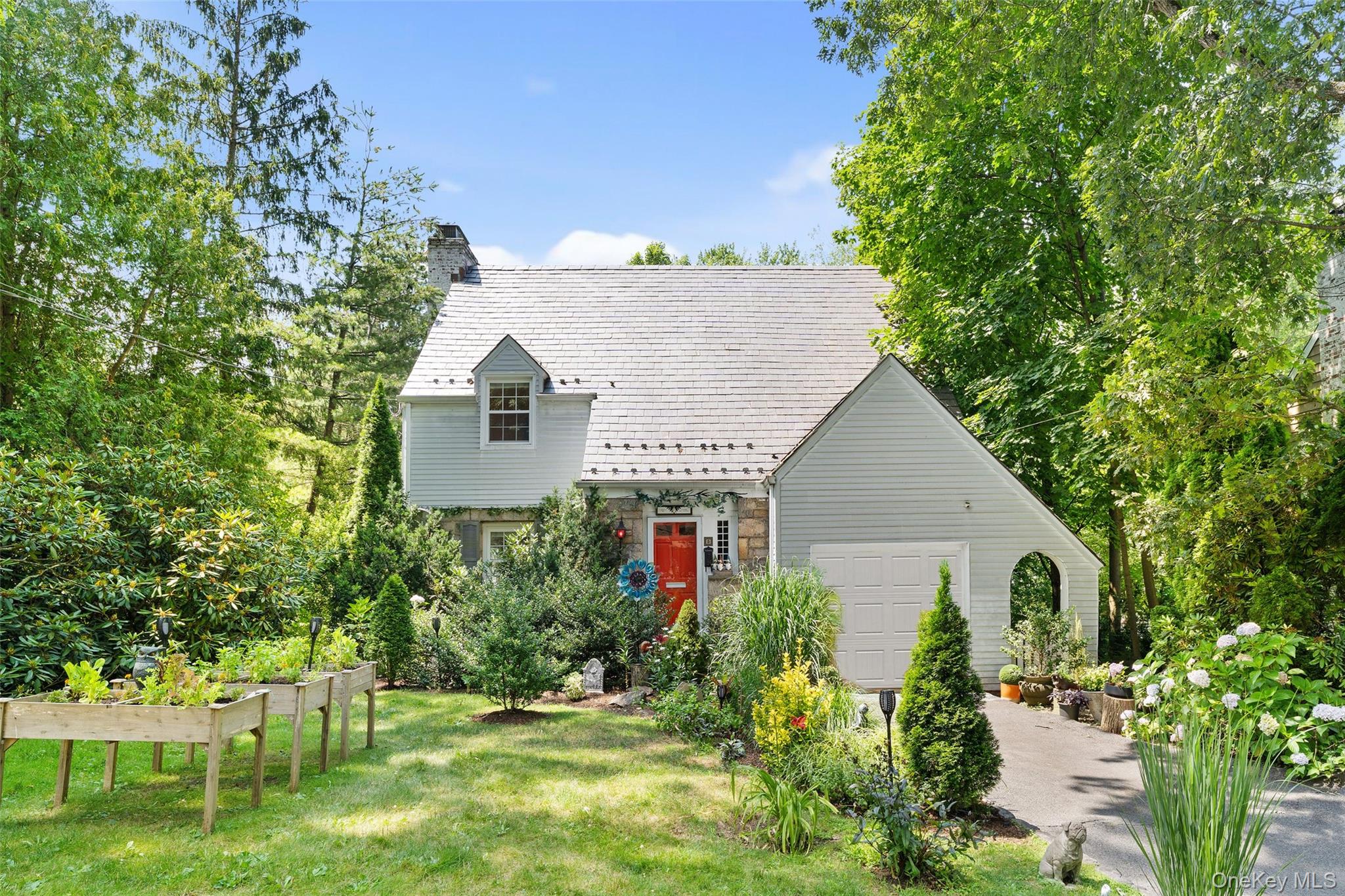 a front view of a house with a yard and trees
