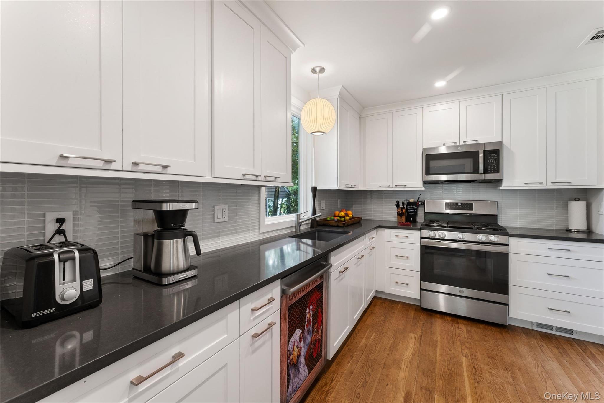 5 Coralyn Road Scarsdale, NY 10583 - Photo 12 of 44 a kitchen with stainless steel appliances granite countertop a sink and a stove