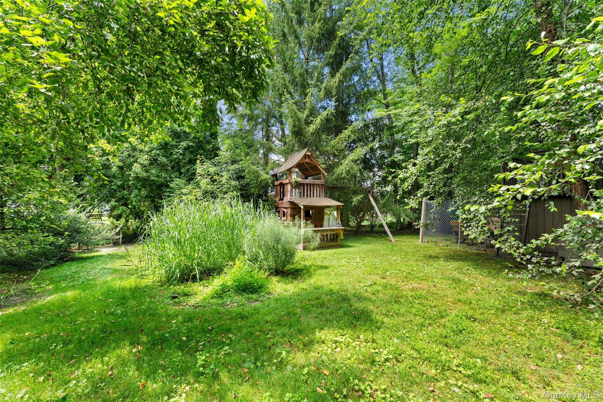 5 Coralyn Road Scarsdale, NY 10583 - Photo 38 of 44 a yellow house in middle of the green field