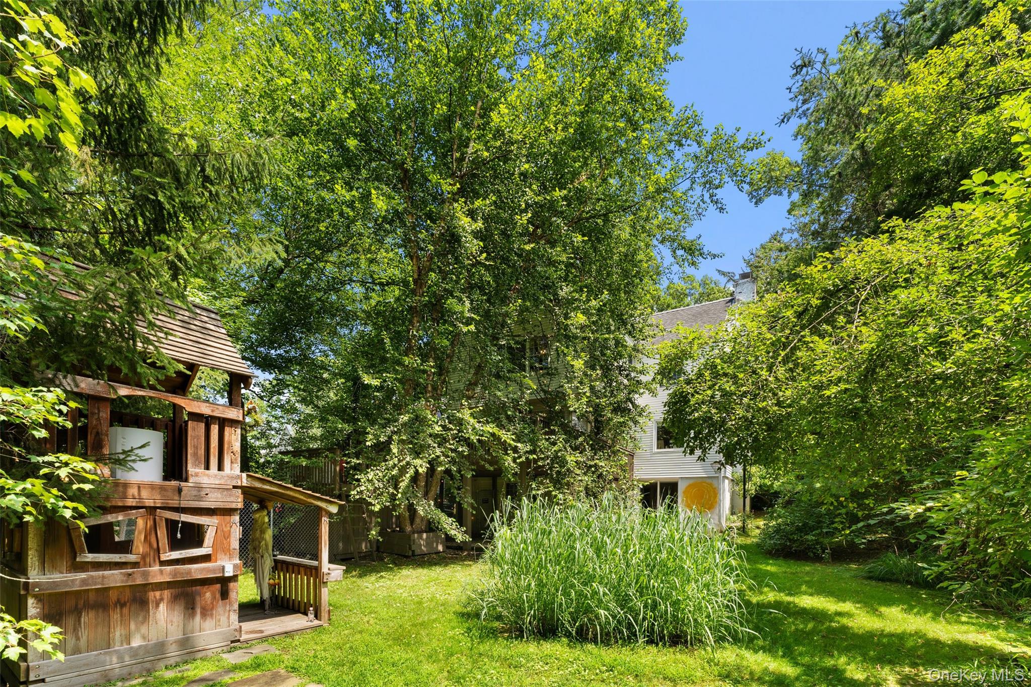 5 Coralyn Road Scarsdale, NY 10583 - Photo 39 of 44 a backyard of a house with lots of green space