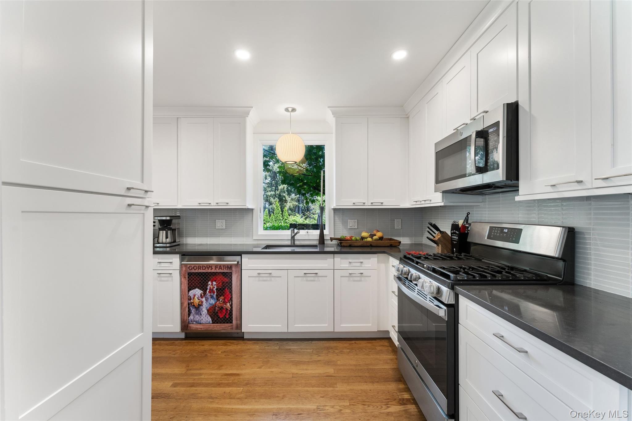 5 Coralyn Road Scarsdale, NY 10583 - Photo 10 of 44 a kitchen with stainless steel appliances granite countertop a stove a sink and a microwave