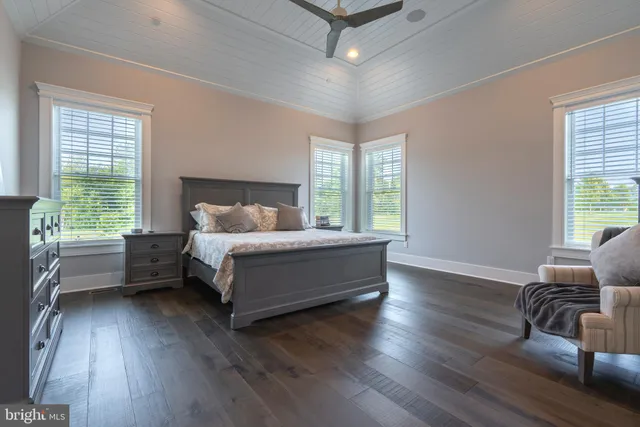 a spacious bedroom with a bed and window