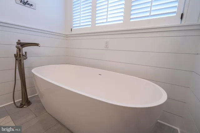 a living room with furniture a flat screen tv and a wooden floor