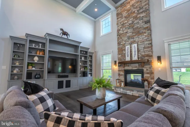 a living room with furniture a fireplace and a flat screen tv
