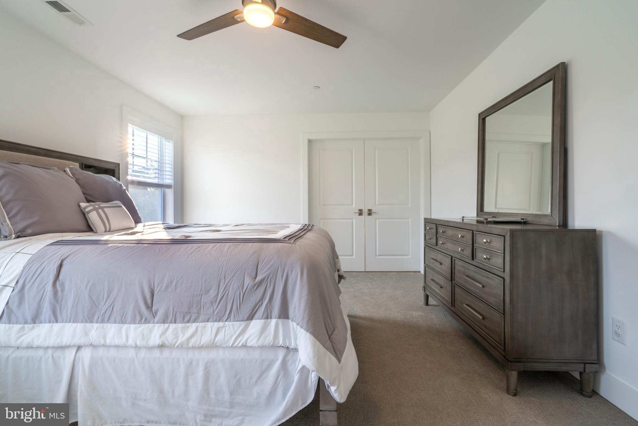 1161 Upper Stump Road Chalfont, PA 18914 - Photo 58 of 102 a bedroom with a bed and dresser with mirror