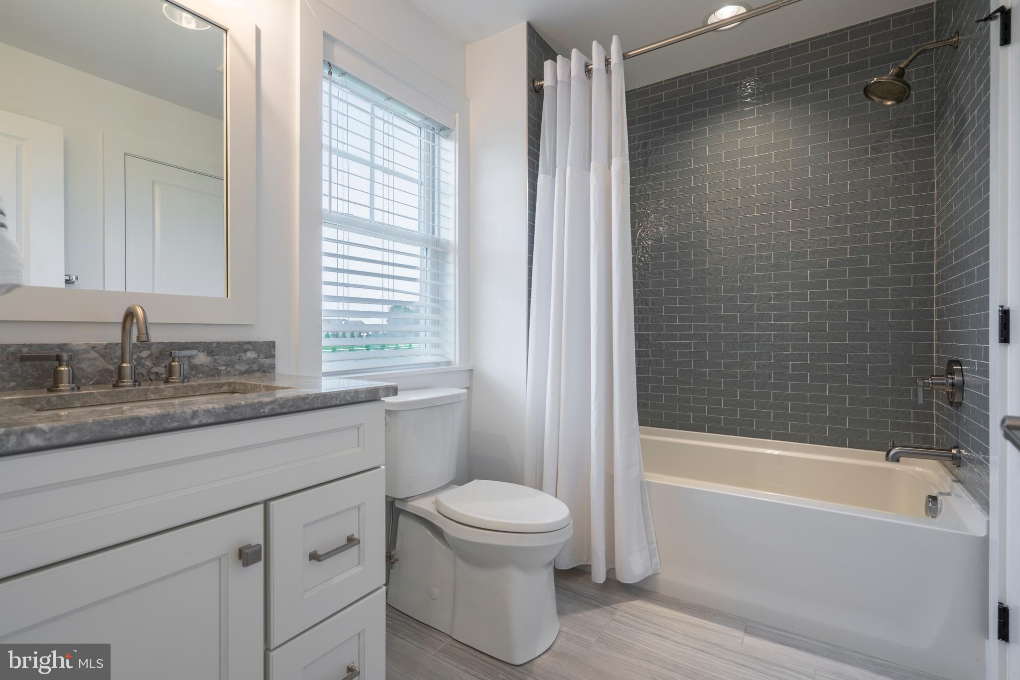 1161 Upper Stump Road Chalfont, PA 18914 - Photo 62 of 102 a bathroom with a granite countertop sink a toilet and bathtub