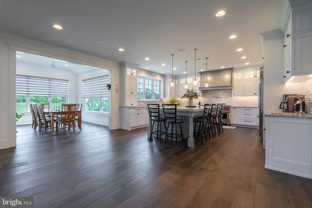 a dining room with furniture window and wooden floor