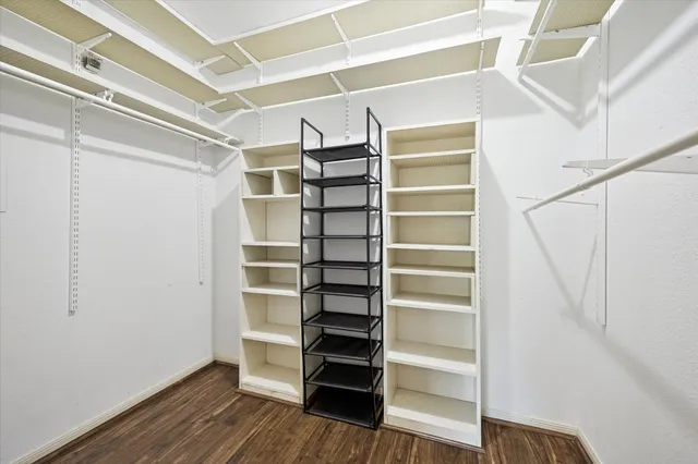 a view of walk in closet with empty racks