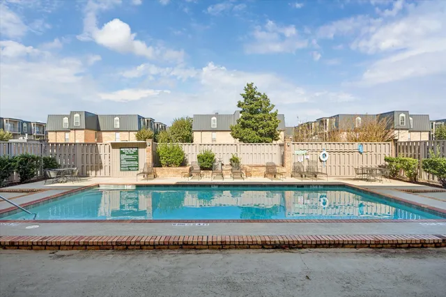 a view of a swimming pool with a yard