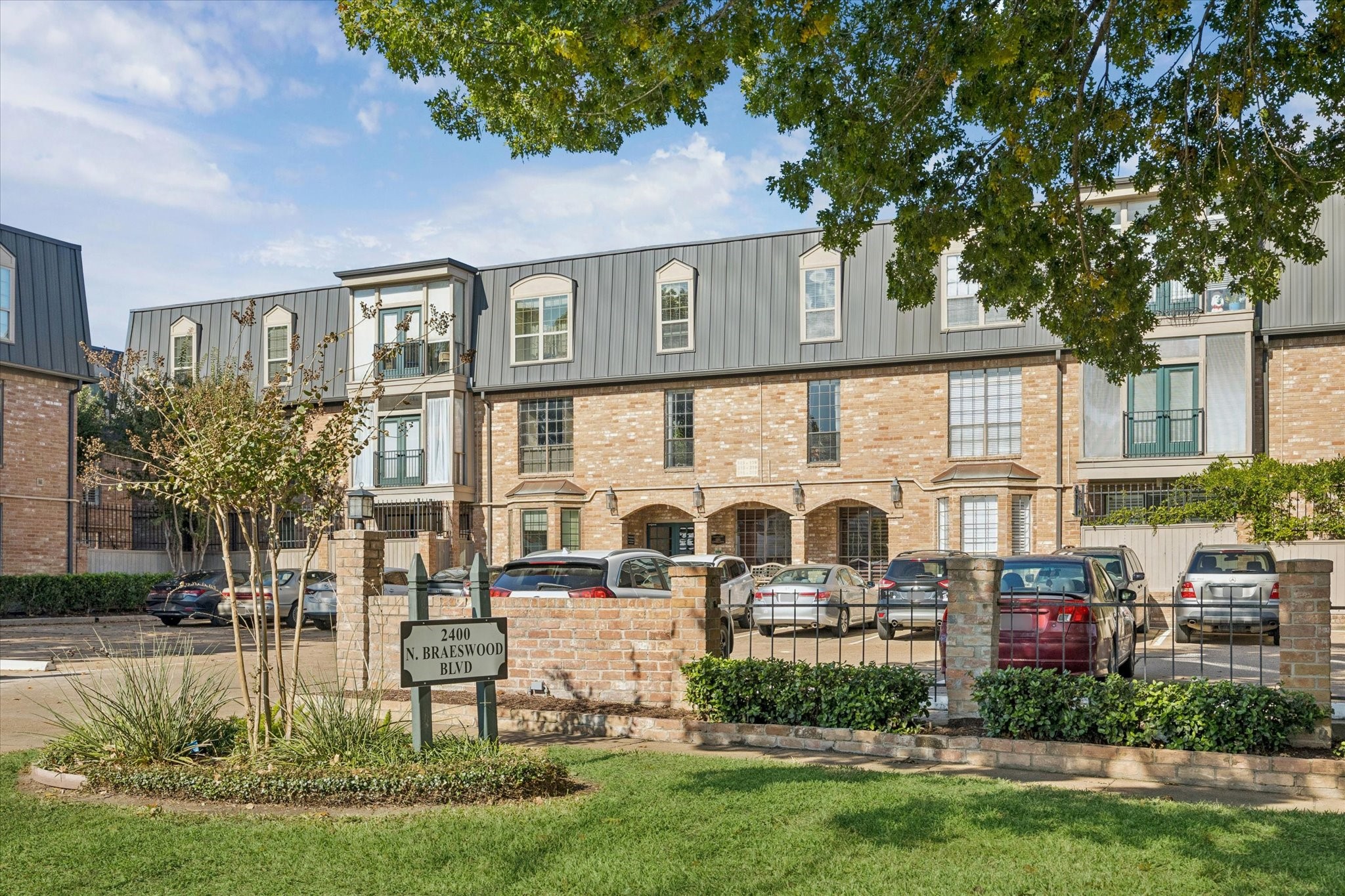 2400 North Braeswood Boulevard, Unit 301 Houston, TX 77030 - Photo 19 of 21 a front view of a house with a garden and plants