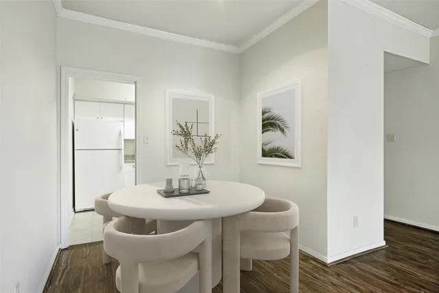 a dining room with furniture and wooden floor