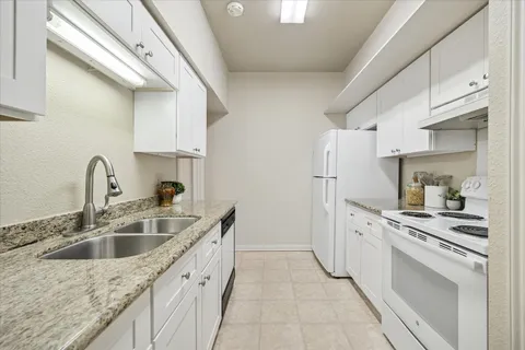 a kitchen with a sink stove and refrigerator