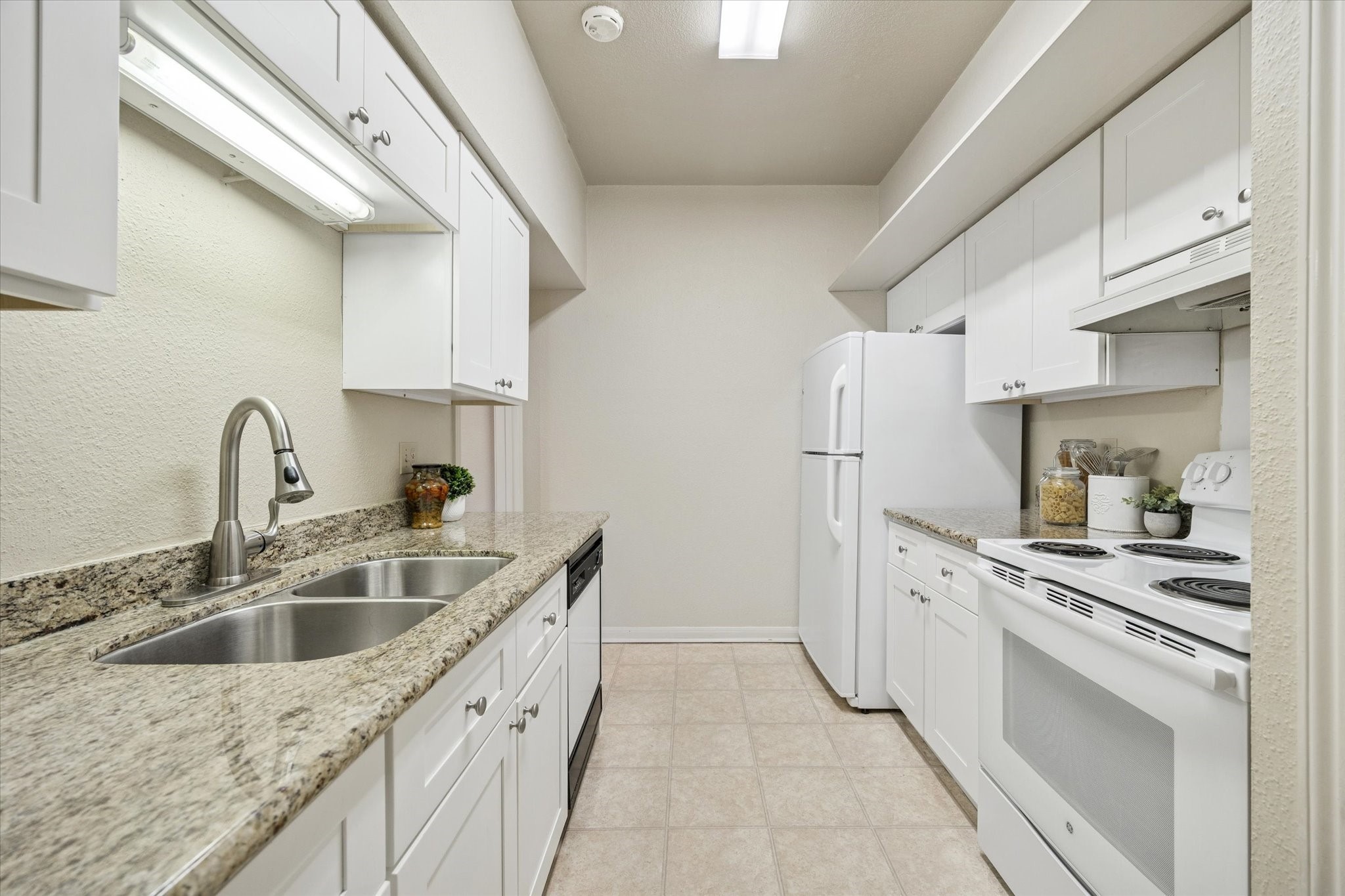 2400 North Braeswood Boulevard, Unit 301 Houston, TX 77030 - Photo 8 of 21 a kitchen with a sink stove and refrigerator