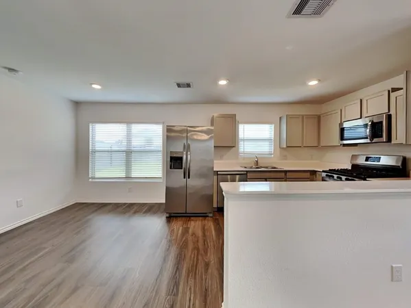 a kitchen with cabinets stainless steel appliances and a sink