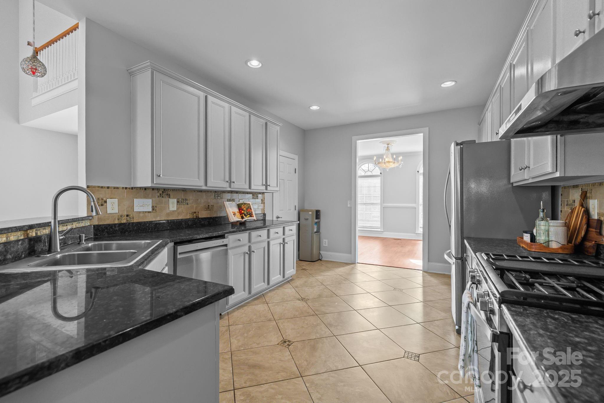 4424 Sunset Rose Drive Fort Mill, SC 29708 - Photo 11 of 47 a kitchen with stainless steel appliances granite countertop a sink and cabinets
