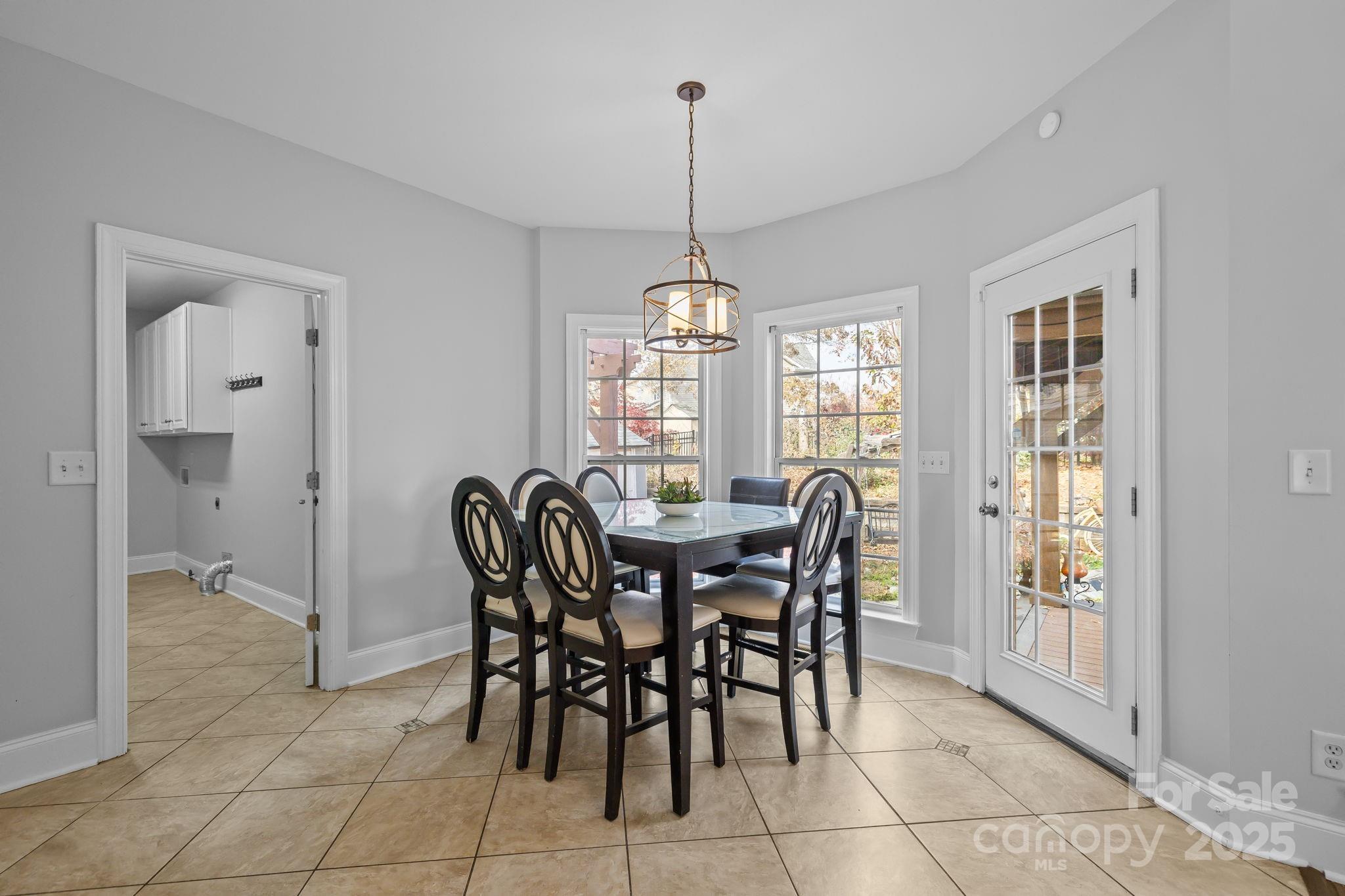 4424 Sunset Rose Drive Fort Mill, SC 29708 - Photo 13 of 47 a dining room with furniture a chandelier and window