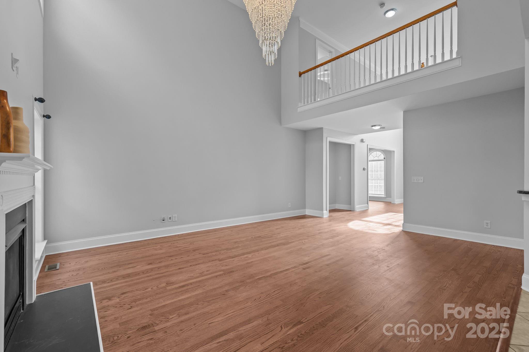 4424 Sunset Rose Drive Fort Mill, SC 29708 - Photo 15 of 47 a view of an empty room with wooden floor and a fireplace