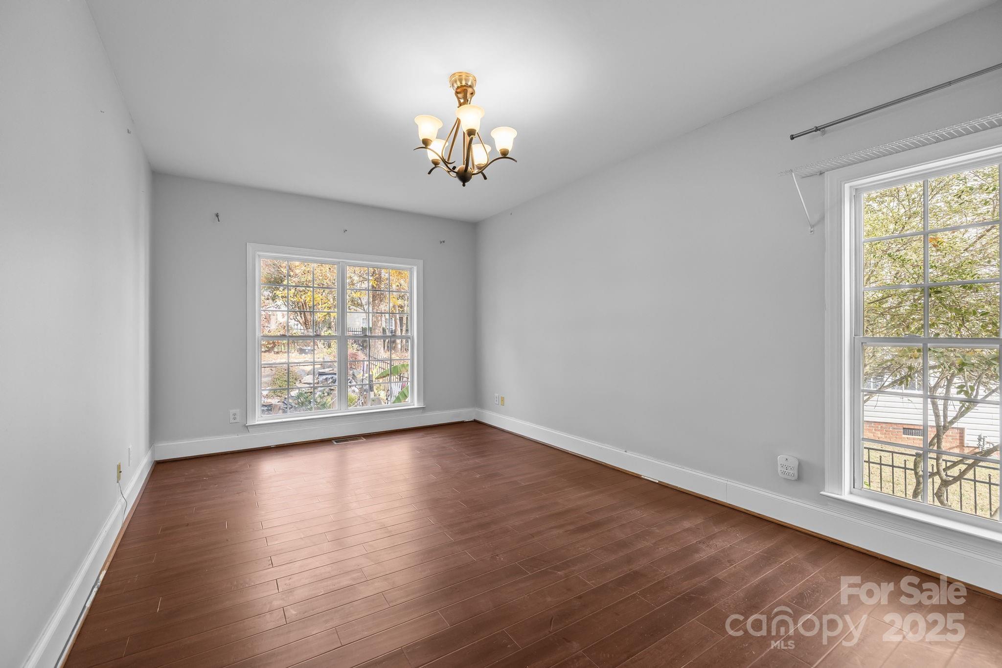 4424 Sunset Rose Drive Fort Mill, SC 29708 - Photo 19 of 47 a view of an empty room with wooden floor and a window