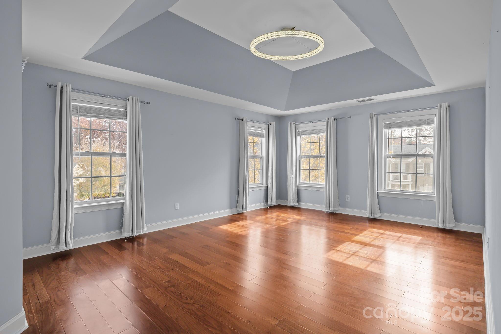 4424 Sunset Rose Drive Fort Mill, SC 29708 - Photo 22 of 47 an empty room with wooden floor and windows
