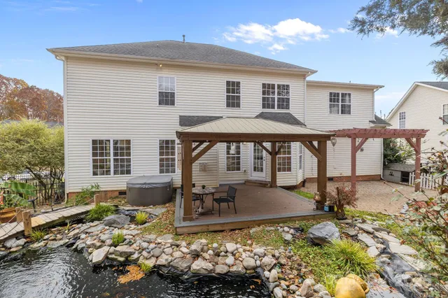 a view of a house with backyard porch and sitting area