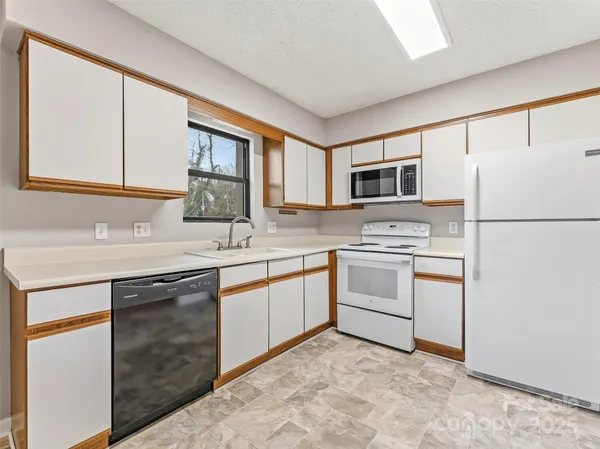 a kitchen with a sink stove and refrigerator