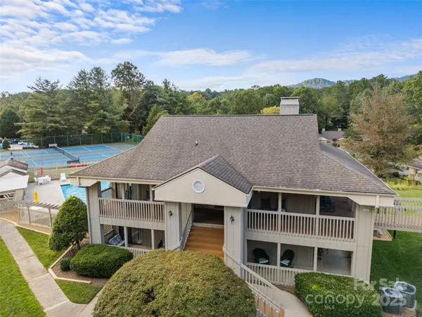 a aerial view of a house next to a yard