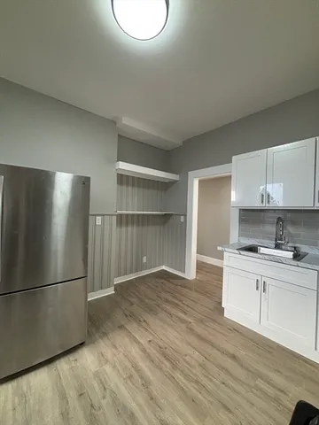 a kitchen with a refrigerator and a sink