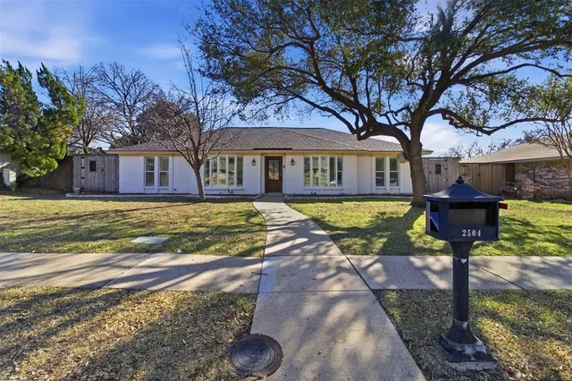 a view of a house with a yard covered with snow in front of house