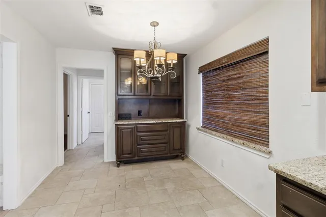 a room with chandelier and window