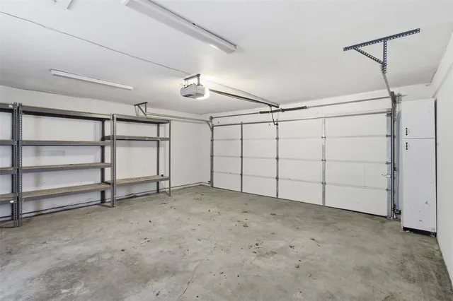 a view of a room with a ceiling fan and wooden floor
