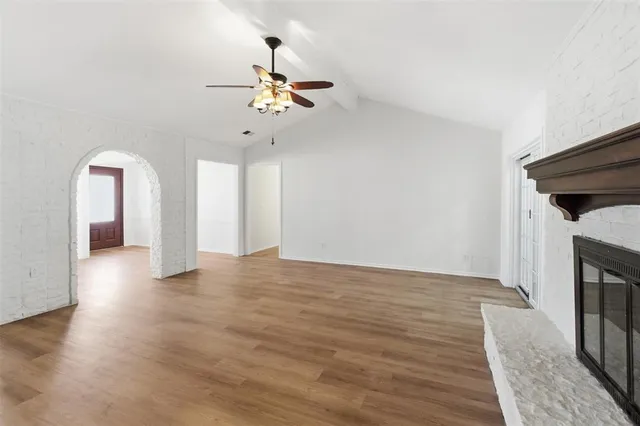 a view of a livingroom with wooden floor and a ceiling fan