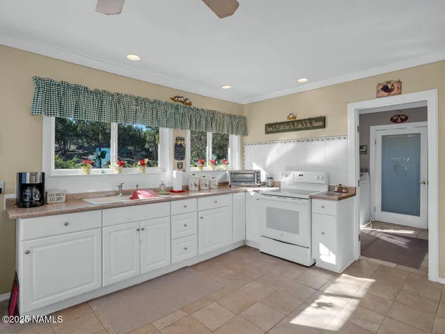 a kitchen with sink cabinets and window