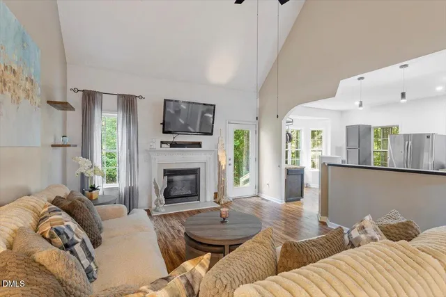a living room with furniture flat screen tv and a fireplace