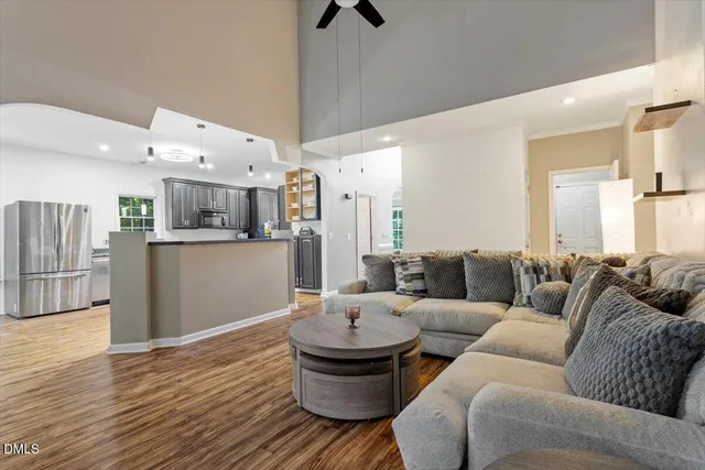 a living room with furniture and a wooden floor