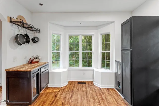 a kitchen with stainless steel appliances kitchen island granite countertop a stove and a refrigerator
