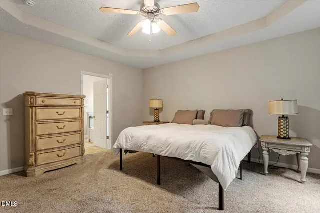 a bedroom with a bed chandelier and a window