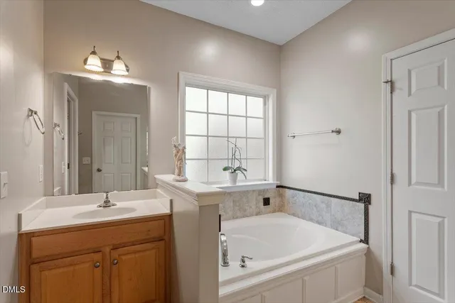 a bathroom with a double vanity sink mirror and shower